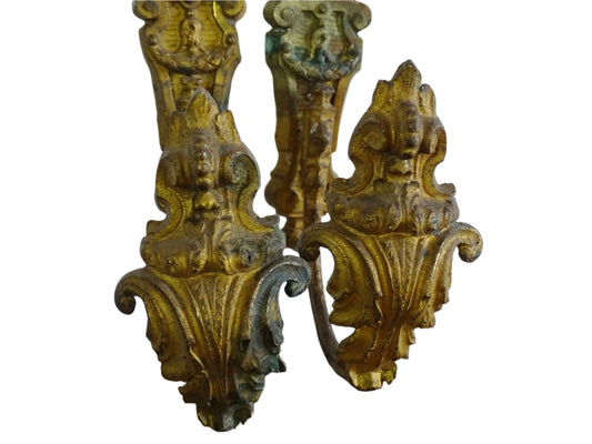 Pair of French antique curtain holdbacks in rococo style. Gilt bronze hooks adorned with swirling, acanthus leaf motifs