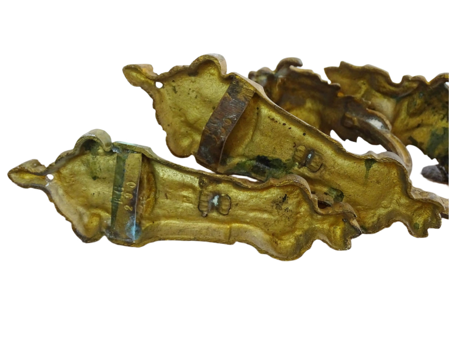 Pair of French antique curtain holdbacks in rococo style. Gilt bronze hooks adorned with swirling, acanthus leaf motifs