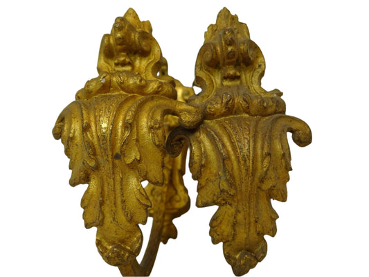 Pair of French antique curtain holdbacks in gilt bronze. These rococo style hooks are adorned with acanthus leaf motifs.