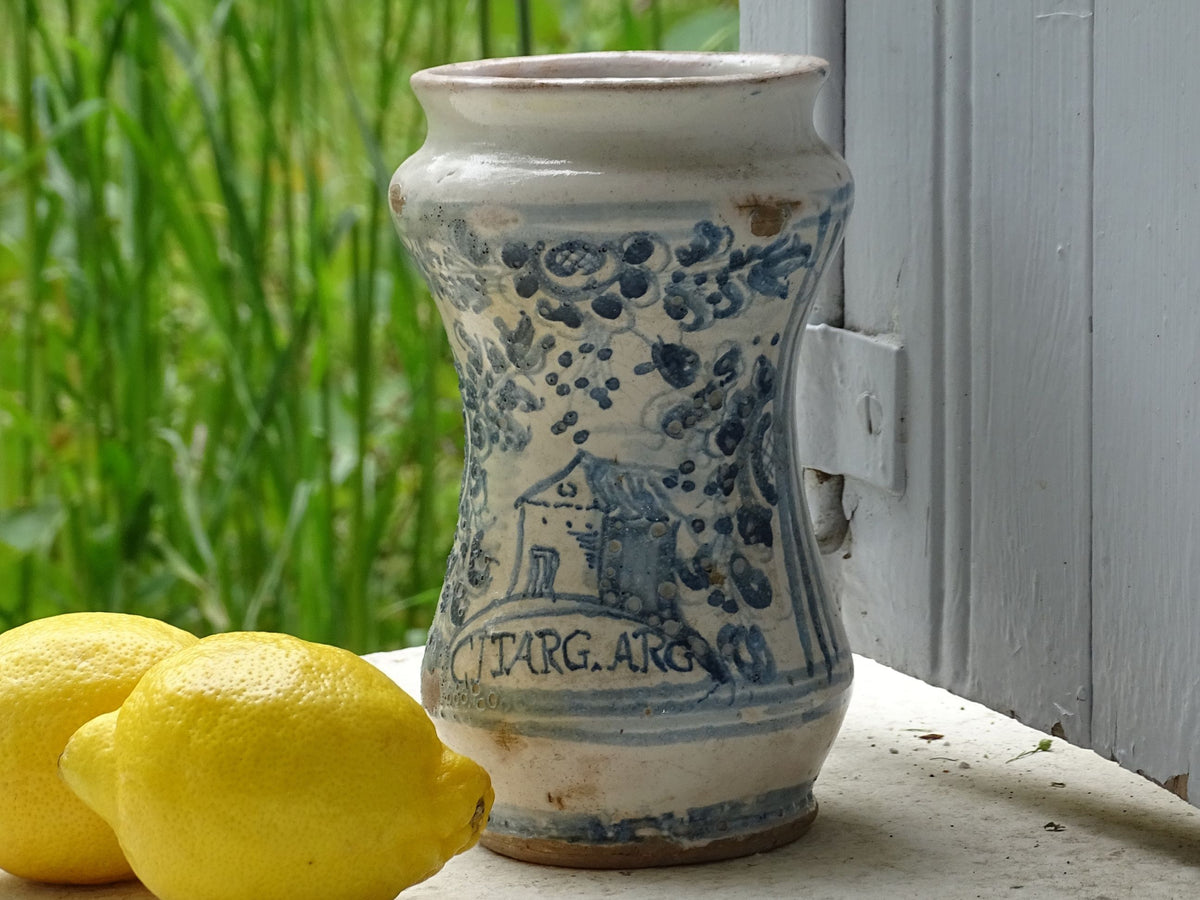 Italian albarello medicine jar from the 18th century, a tin-glazed, blue and white earthenware jar hand-painted with flowers, foliage and a naive house, dated 1763
