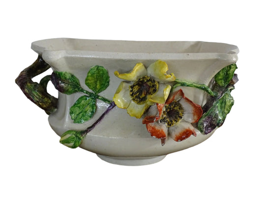 French antique barbotine ceramic planter from Monaco. One side is decorated with green leaves and purple flower buds, the other with red and yellow flowers. Highly decorative majolica pottery jardiniere.