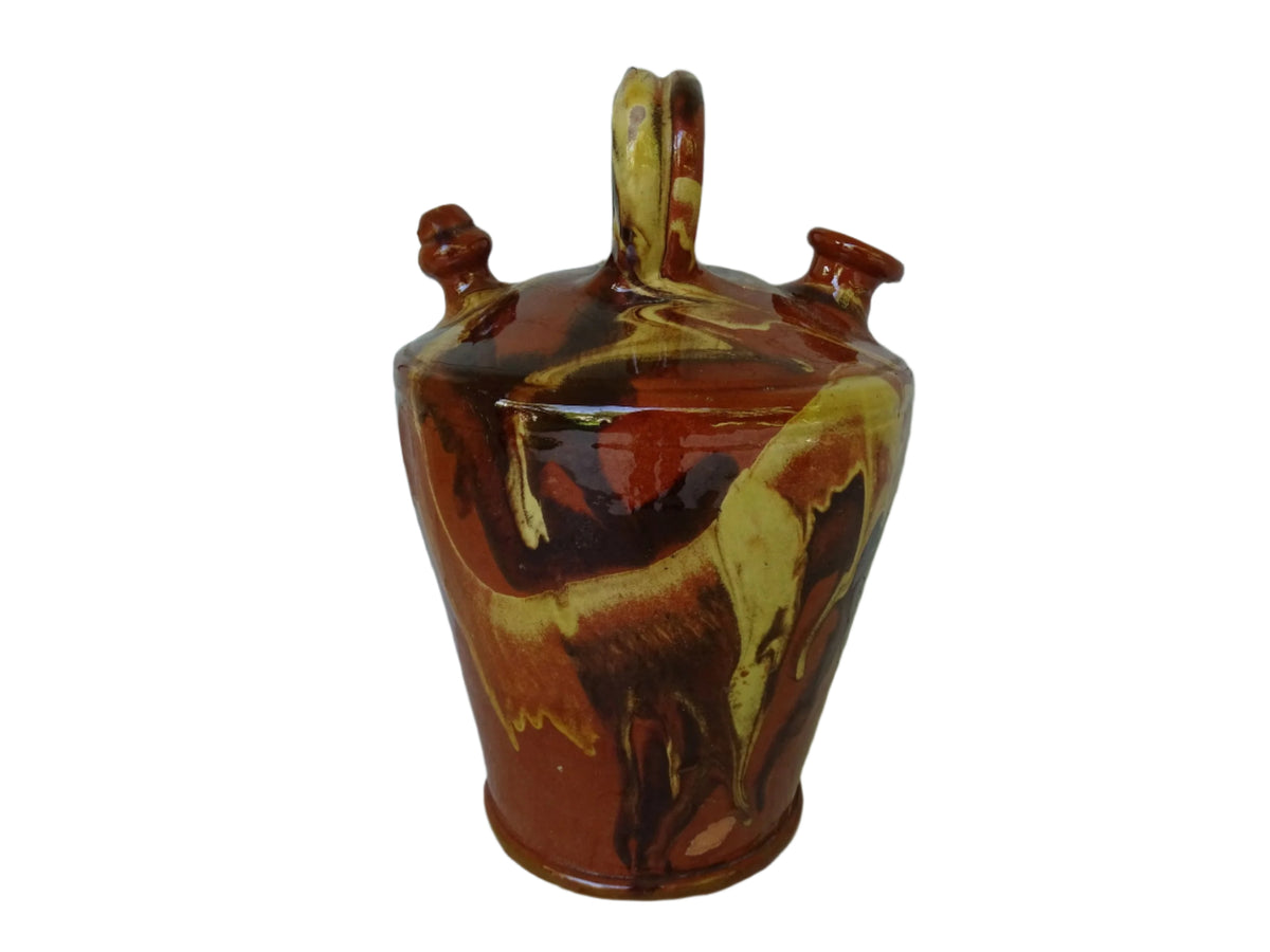 Rustic Catalan antique pottery gargoulette with a jaspé glaze in yellow or brown. The body of this marble glazed terracotta water jug has a sturdy handle to the top and two spouts.