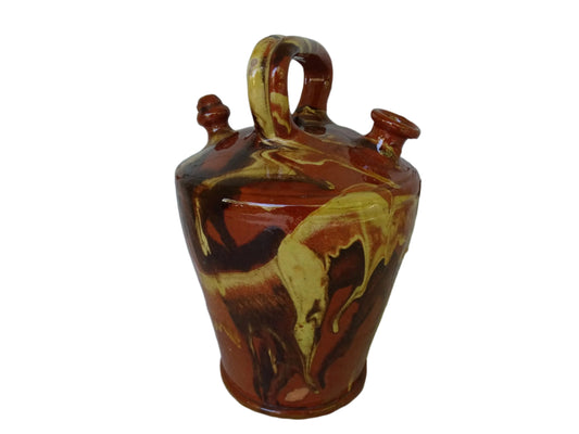 Rustic Catalan antique pottery gargoulette with a jaspé glaze in yellow or brown. The body of this marble glazed terracotta water jug has a sturdy handle to the top and two spouts.