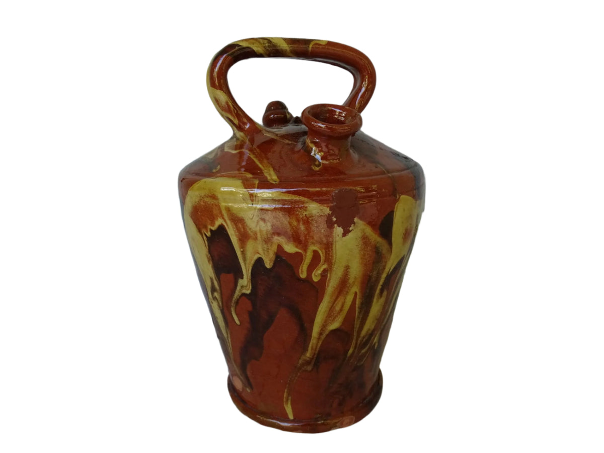 Rustic Catalan antique pottery gargoulette with a jaspé glaze in yellow or brown. The body of this marble glazed terracotta water jug has a sturdy handle to the top and two spouts.