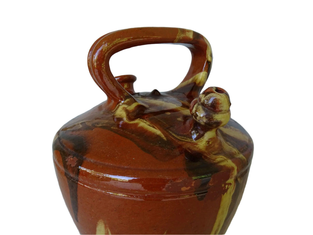 Rustic Catalan antique pottery gargoulette with a jaspé glaze in yellow or brown. The body of this marble glazed terracotta water jug has a sturdy handle to the top and two spouts.