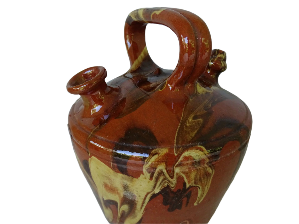 Rustic Catalan antique pottery gargoulette with a jaspé glaze in yellow or brown. The body of this marble glazed terracotta water jug has a sturdy handle to the top and two spouts.