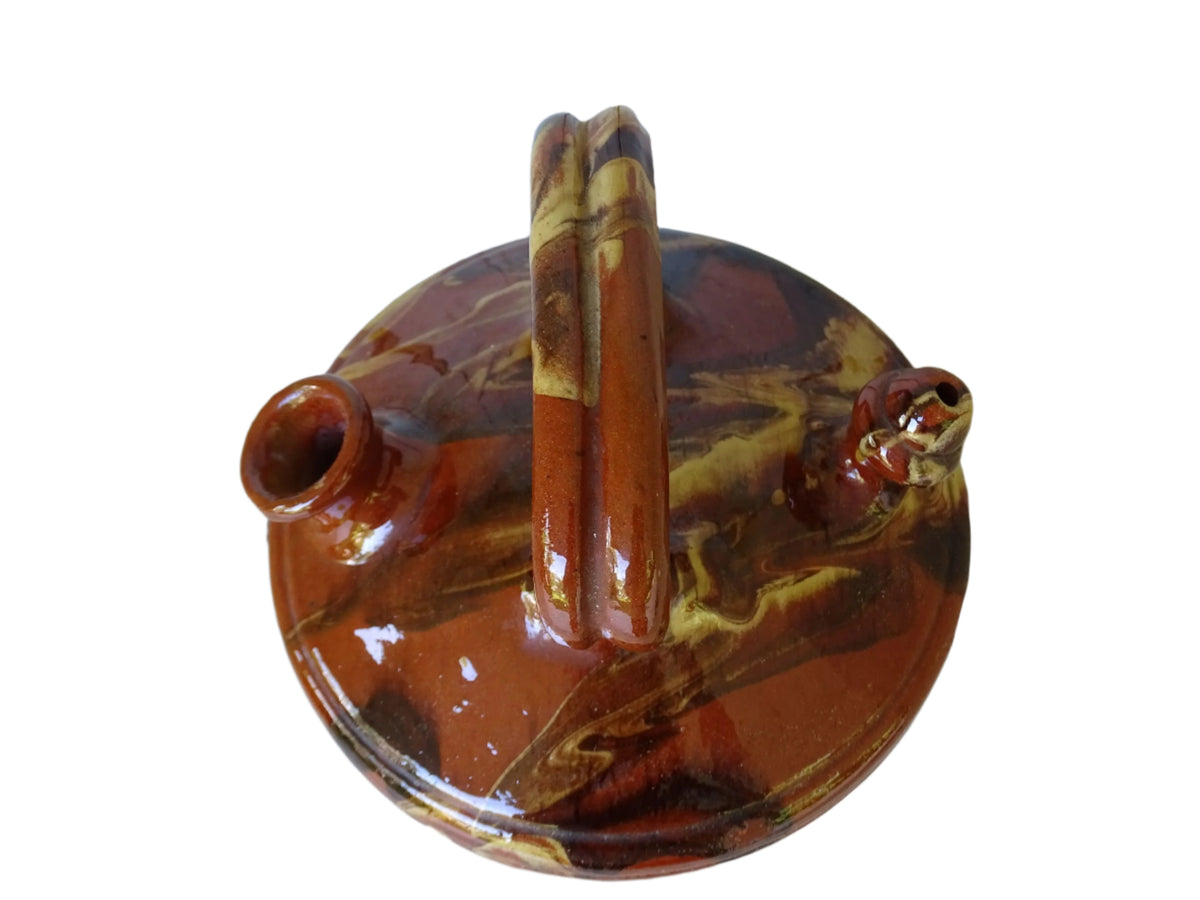 Rustic Catalan antique pottery gargoulette with a jaspé glaze in yellow or brown. The body of this marble glazed terracotta water jug has a sturdy handle to the top and two spouts.