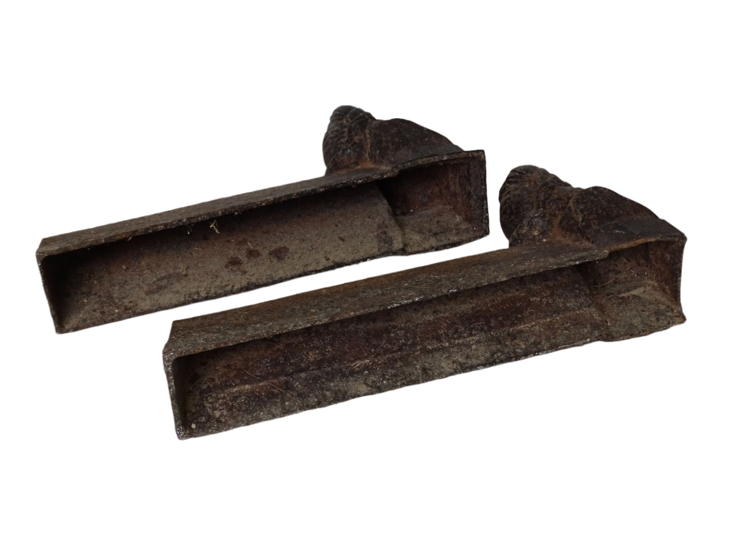 Set beneath each bust are the initials C.T., likely denoting the foundry or workshop where the andirons were cast. They're richly patinated with surface rust and texture.