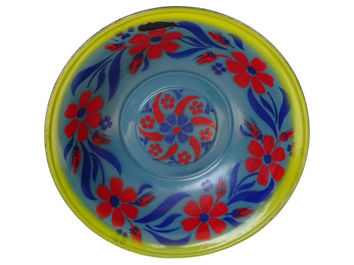 French vintage enamelled bowl with blue background, red flowers and a yellow trim.