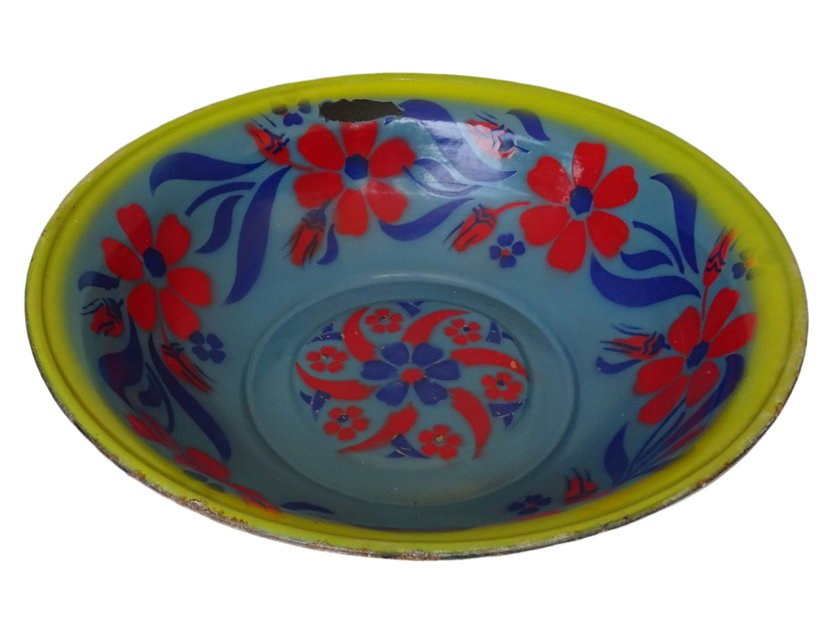 French vintage enamelled bowl with blue background, red flowers and a yellow trim.