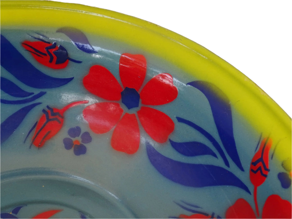 French vintage enamelled bowl with blue background, red flowers and a yellow trim.
