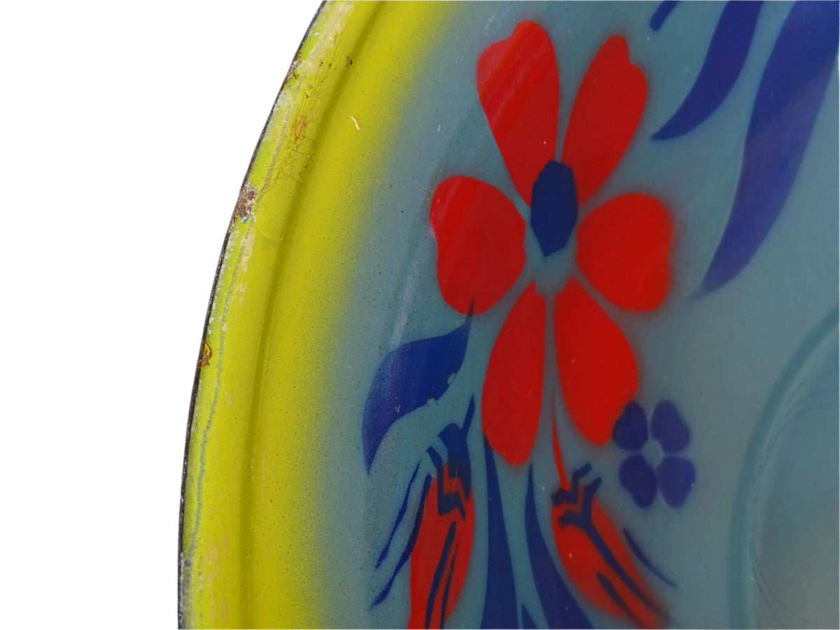 French vintage enamelled bowl with blue background, red flowers and a yellow trim.
