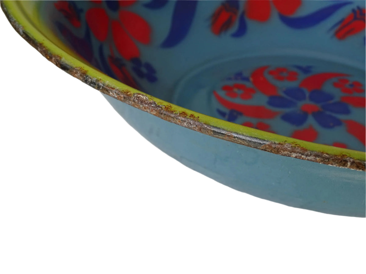 French vintage enamelled bowl with blue background, red flowers and a yellow trim.