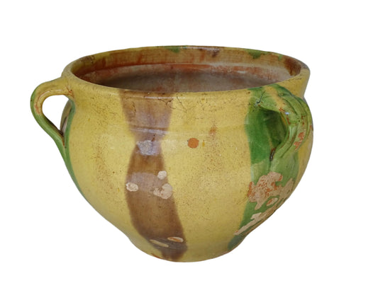 French antique glazed terracotta planter from Castelnaudary. The ceramic pot has a stripe drip glaze in yellow, green and brown. This antique cache pot has four loop handles.