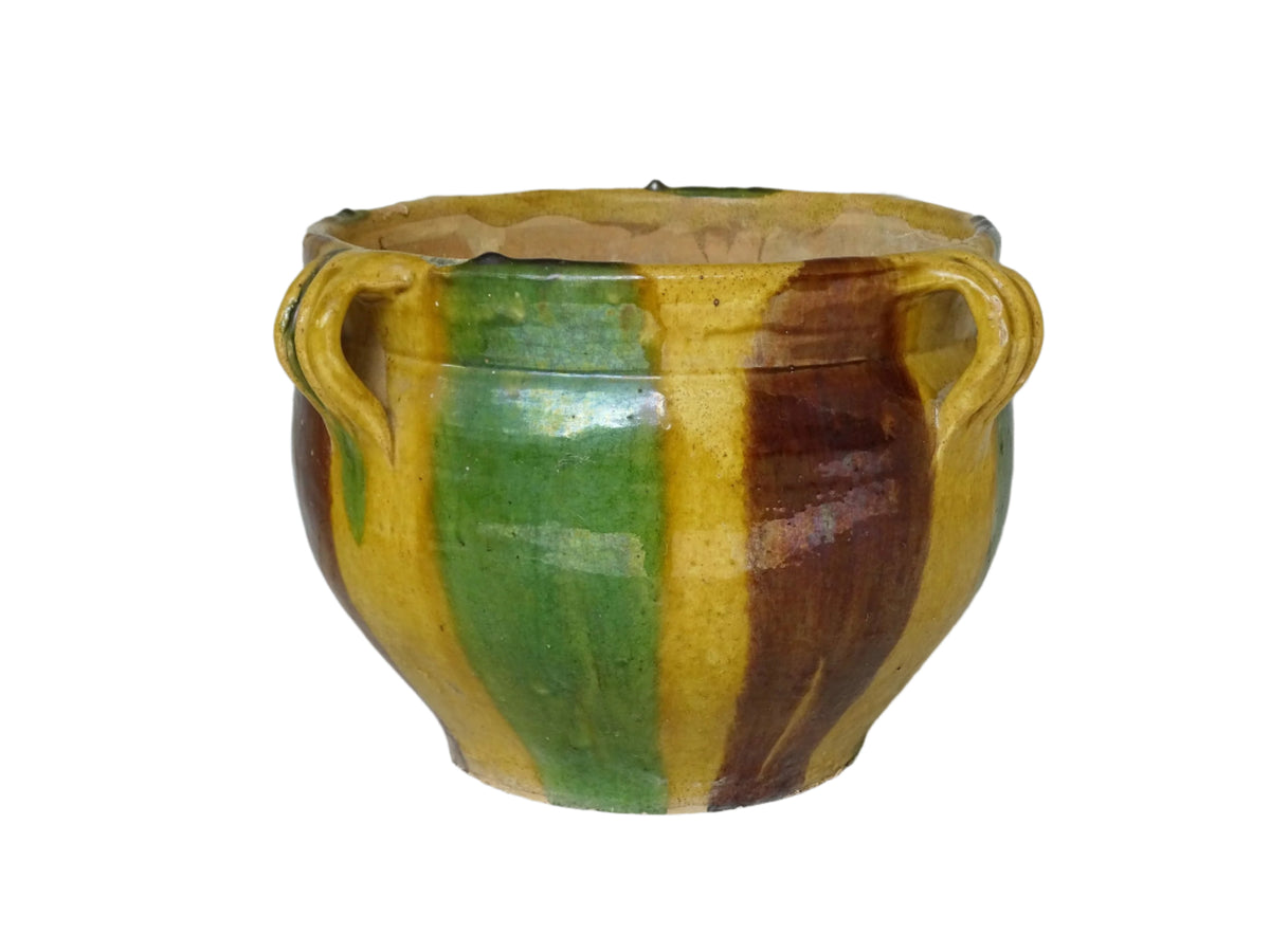 French antique terracotta planter from Castelnaudary. 19th century jardinière with a stripe drip glaze in yellow, green and brown. Antique earthenware pot with four loop handles.