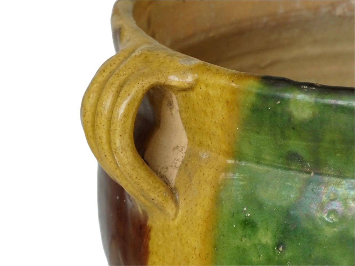 French antique terracotta planter from Castelnaudary. 19th century jardinière with a stripe drip glaze in yellow, green and brown. Antique earthenware pot with four loop handles.