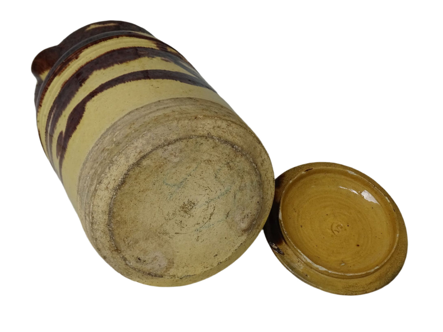 Large French antique ceramic pitcher with a lid. The glazed pottery jug has a gorgeous brown drip glaze on a yellow glazed background.