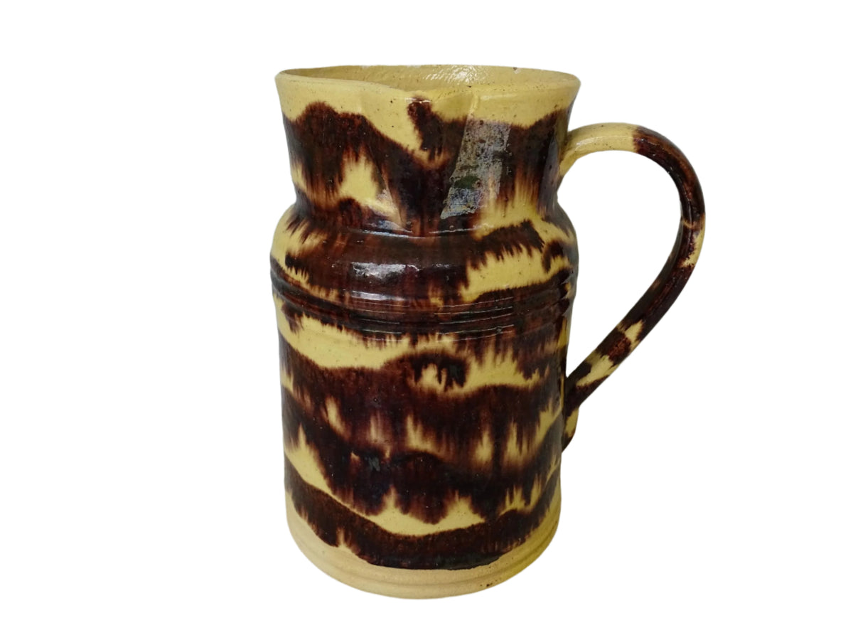 Rustic French antique ceramic pitcher with yellow glaze and brown drip glaze detailing. This Dieulefit pottery jug has a handle to the side.