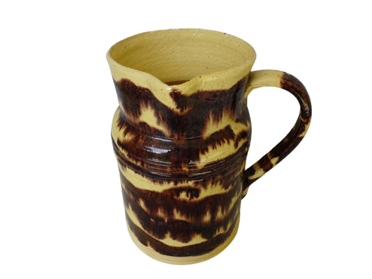 Rustic French antique ceramic pitcher with yellow glaze and brown drip glaze detailing. This Dieulefit pottery jug has a handle to the side.