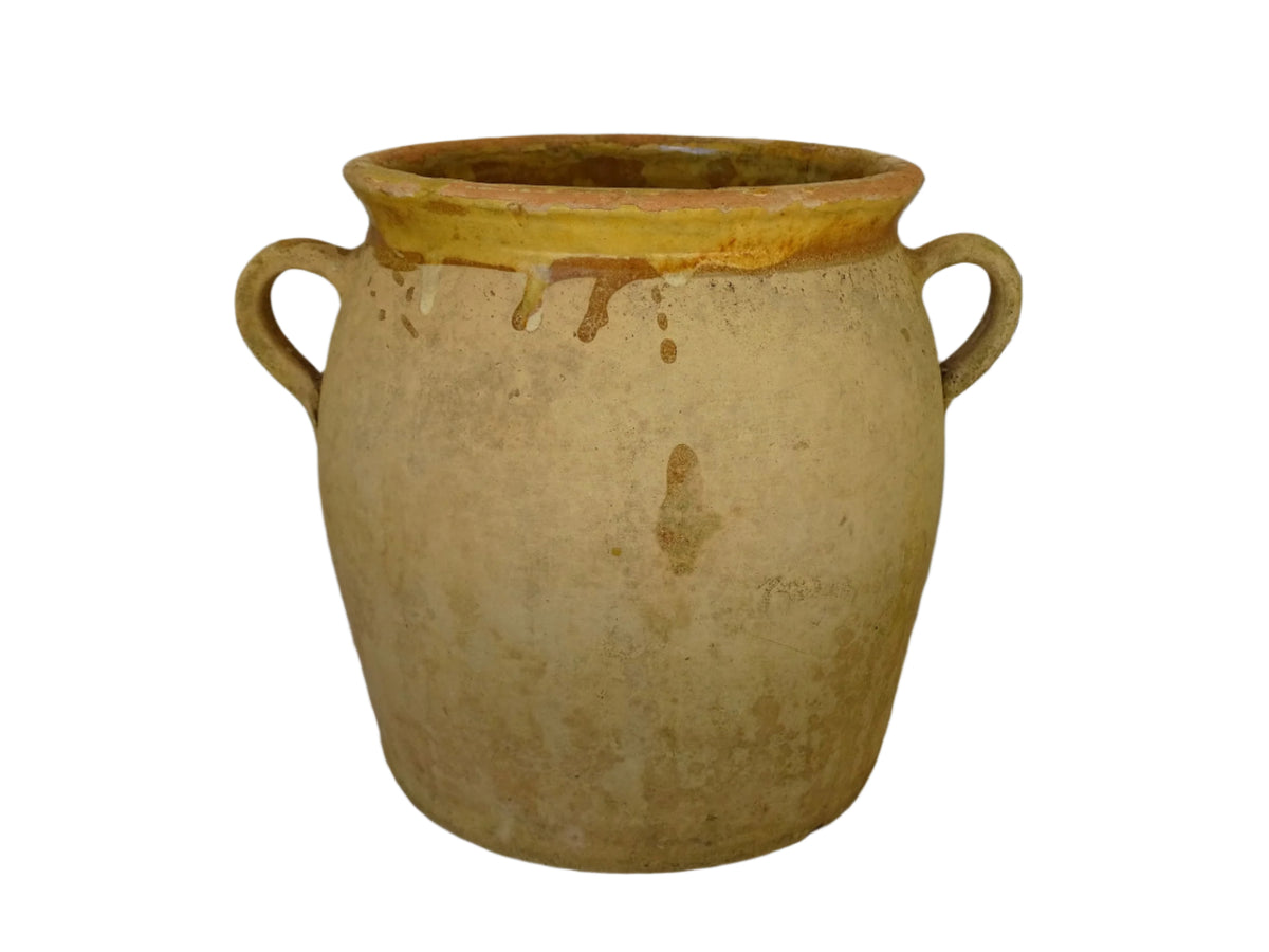 French antique confit pot with a yellow glazed interior and unglazed terracotta exterior.