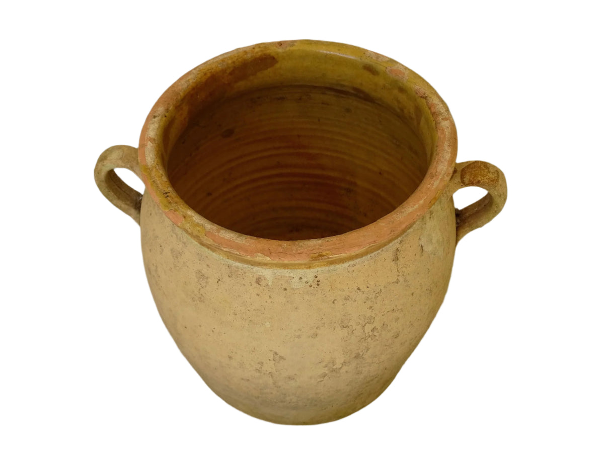 French antique confit pot with a yellow glazed interior and unglazed terracotta exterior.