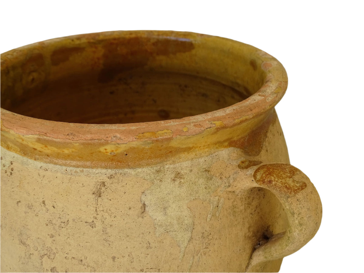French antique confit pot with a yellow glazed interior and unglazed terracotta exterior.
