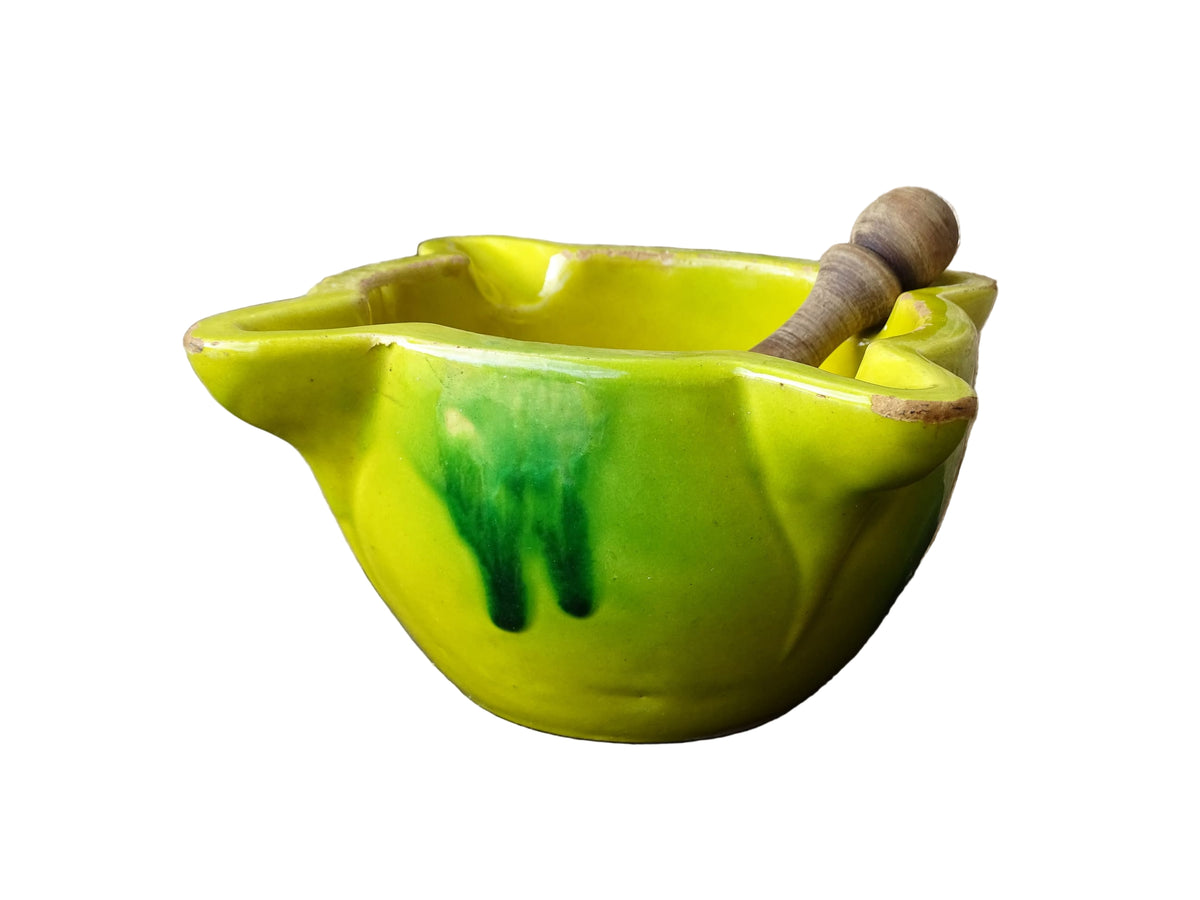 French vintage ceramic pestle and mortar with a yellow glaze and green drip glaze detailing. Wooden pestle with patina.