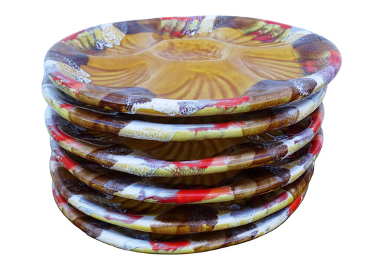 Stack of French vintage ceramic oyster plates with ochre yellow glaze. Vallauris pottery serving plates.