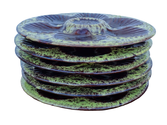 Set of six French vintage Vallauris pottery oyster plates by Maruis Giuge with space for six oysters. They have a yellow and brown glaze.
