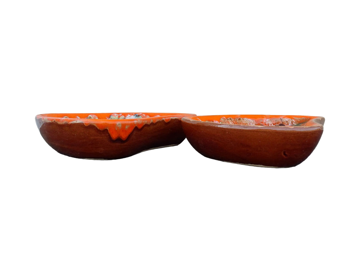 Pair of French vintage Vallauris ceramic dishes. Kidney shaped bowls with orange glaze with mid-century design.