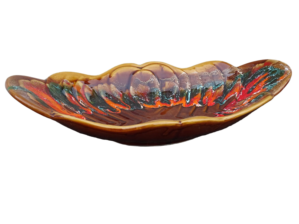 French vintage Vallauris pottery bowl with a brown glaze and red and green detailing. The ceramic centrepiece has a geometric design to the centre and a free flow design to the edge.