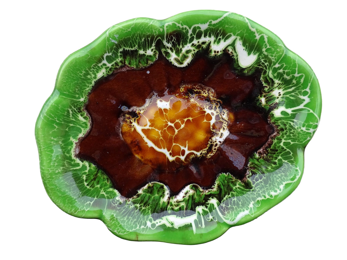 French vintage Vallauris pottery dish with a bright green glaze. To the centre, is an abstract glaze design in brown with hints of white.