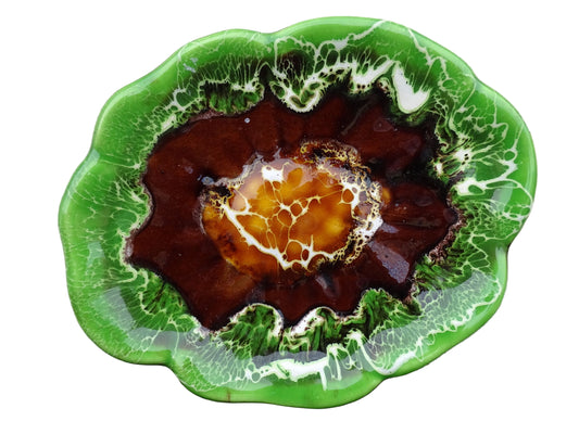 French vintage Vallauris pottery dish with a bright green glaze. To the centre, is an abstract glaze design in brown with hints of white.
