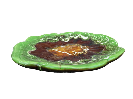 French vintage Vallauris pottery dish with a bright green glaze. To the centre, is an abstract glaze design in brown with hints of white.