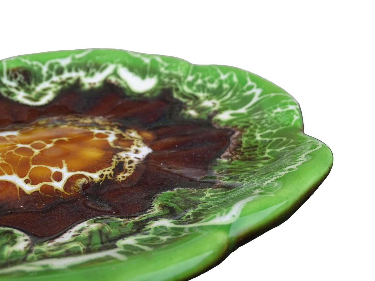 French vintage Vallauris pottery dish with a bright green glaze. To the centre, is an abstract glaze design in brown with hints of white.
