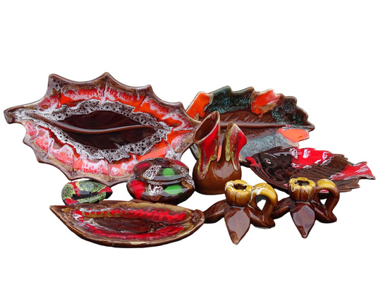 A collection of vintage French Vallauris pottery in bright colours. Including a vase, leaf bowls and candle holders.