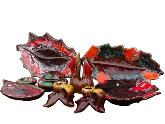 A collection of vintage French Vallauris pottery in bright colours. Including a vase, leaf bowls and candle holders.