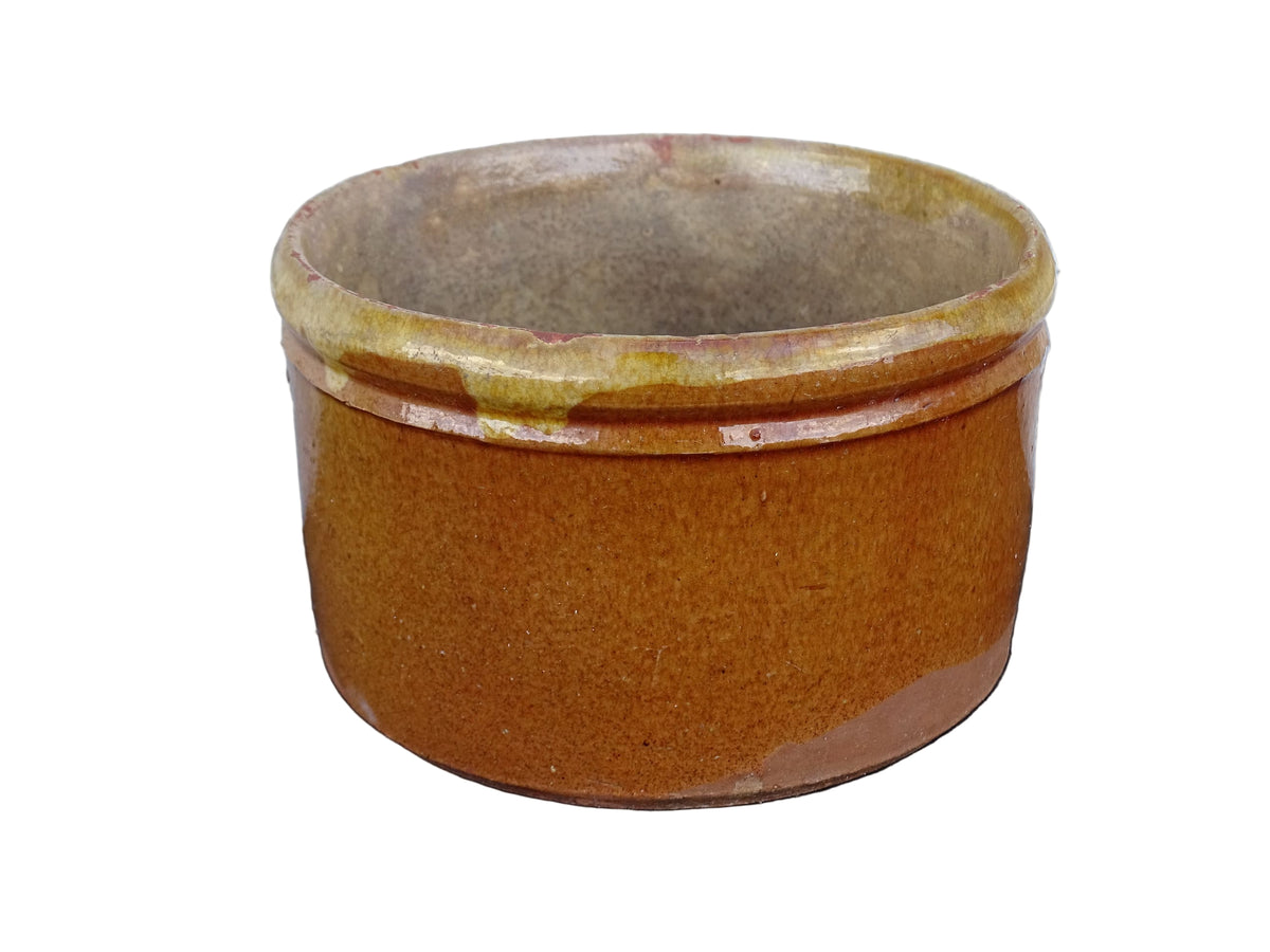 French antique earthenware pot with yellow glaze and timeworn interior.