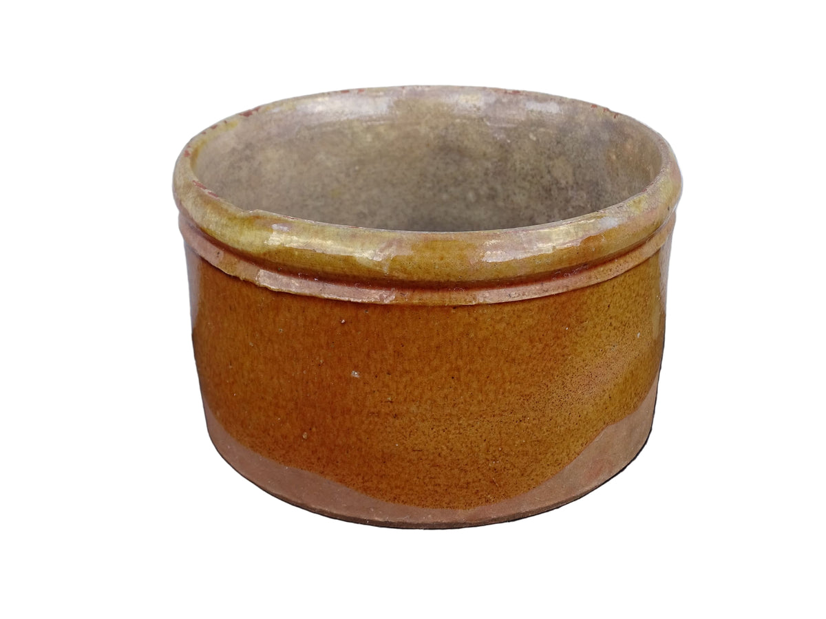French antique earthenware pot with yellow glaze and timeworn interior.