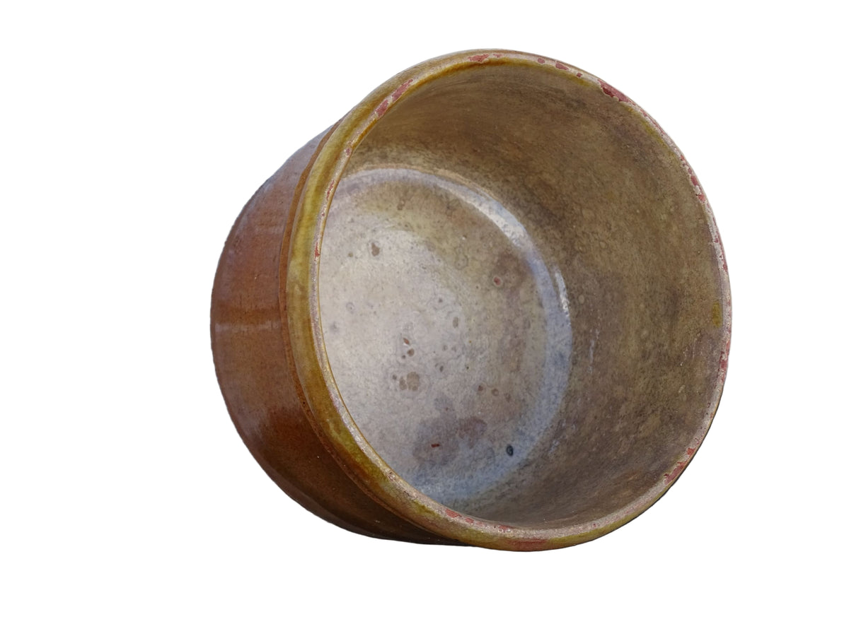 French antique earthenware pot with yellow glaze and timeworn interior.