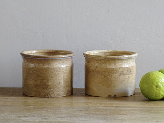 Timeworn French antique ceramic pots by Sarreguemines. 19th century rustic pottery confiture pots for a French country farmhouse display.