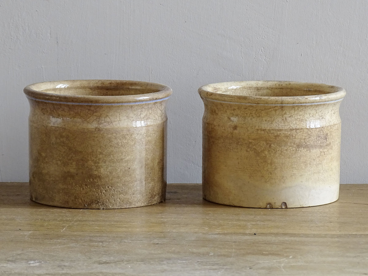 Timeworn French antique ceramic pots by Sarreguemines. 19th century rustic pottery confiture pots for a French country farmhouse display.