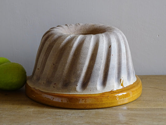 French vintage ceramic mould with a yellow glaze interior and unglazed exterior.
