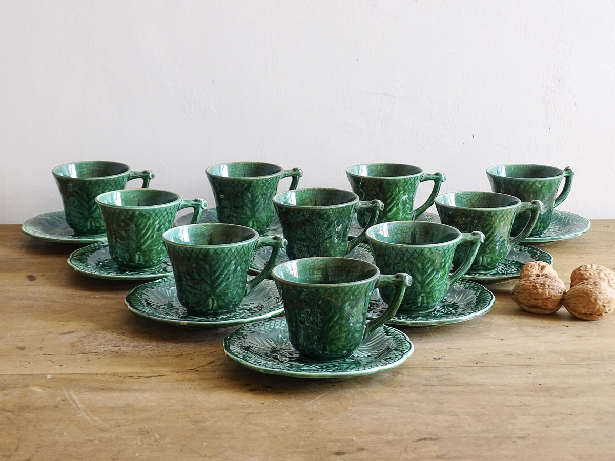 Set of 10 vintage coffee cups by Gien in the Primefleur design with leaf patterns. Green glazed ceramic cups and saucers. Barbotine or majolica cups.