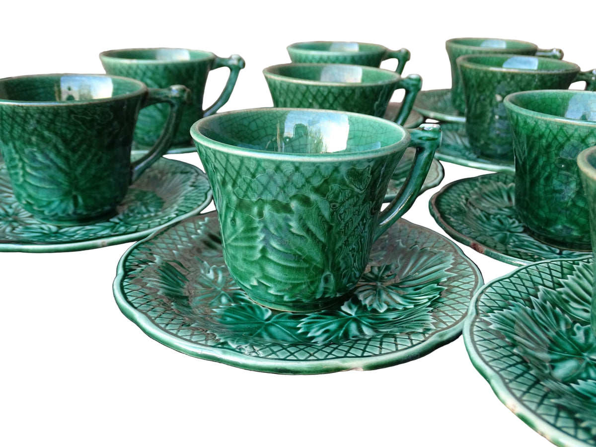 Set of 10 vintage coffee cups by Gien in the Primefleur design with leaf patterns. Green glazed ceramic cups and saucers. Barbotine or majolica cups.