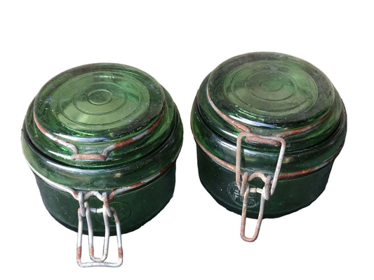 Pair of French vintage green glass jars by Dufor with metal fasteners.