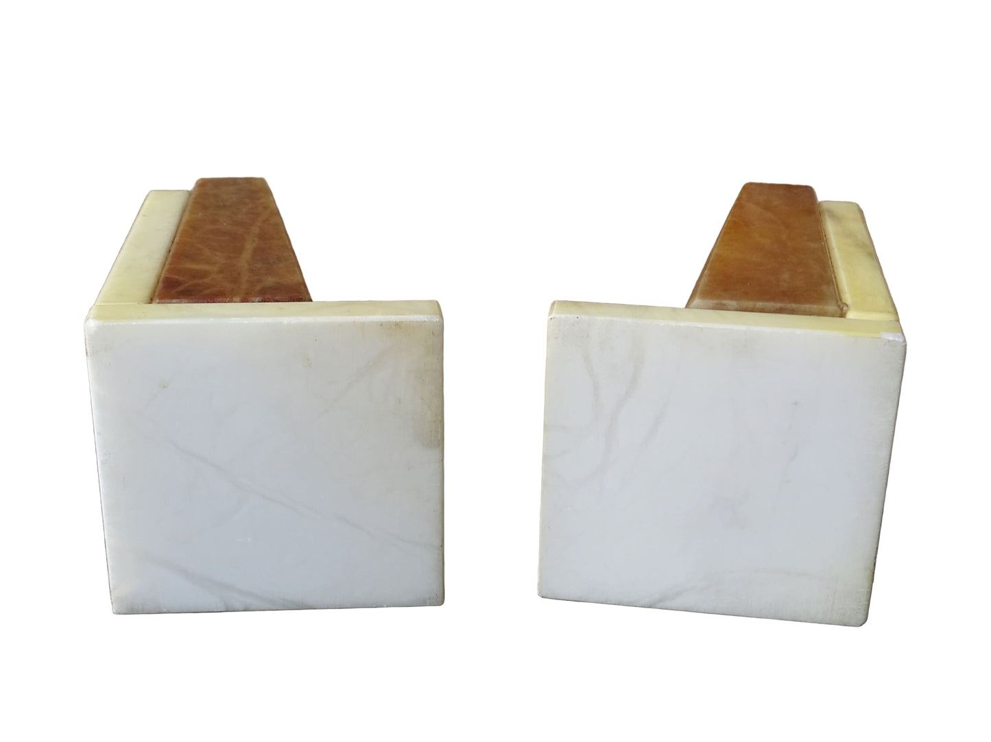 Pair of vintage alabaster bookends with a sculptural look. They have geometric lines with an Art Deco influence. Each bookend has a soft cream alabaster with a warm caramel toned section.