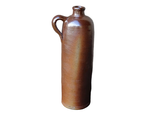 Antique salt glazed stoneware bottle, with a raised lion medallion on the shoulder and a loop handle. Bottle with textured surface and deep brown glaze.