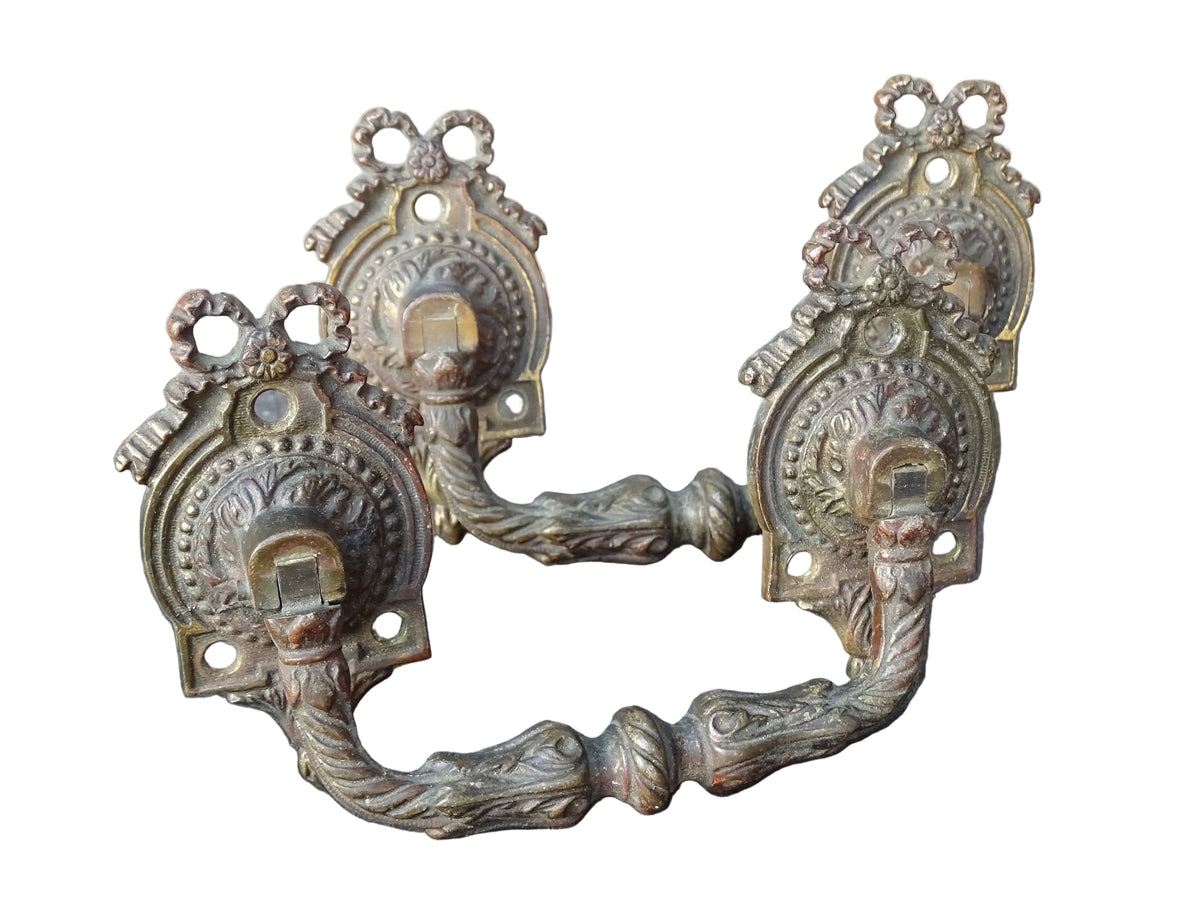 Pair of French antique gilt bronze drawer pulls with ribbon detailing, signed L.Pinet. Nineteenth century ormolu handles.