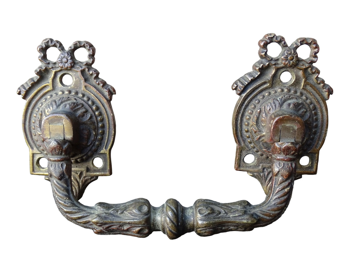 Pair of French antique gilt bronze drawer pulls with ribbon detailing, signed L.Pinet. Nineteenth century ormolu handles.